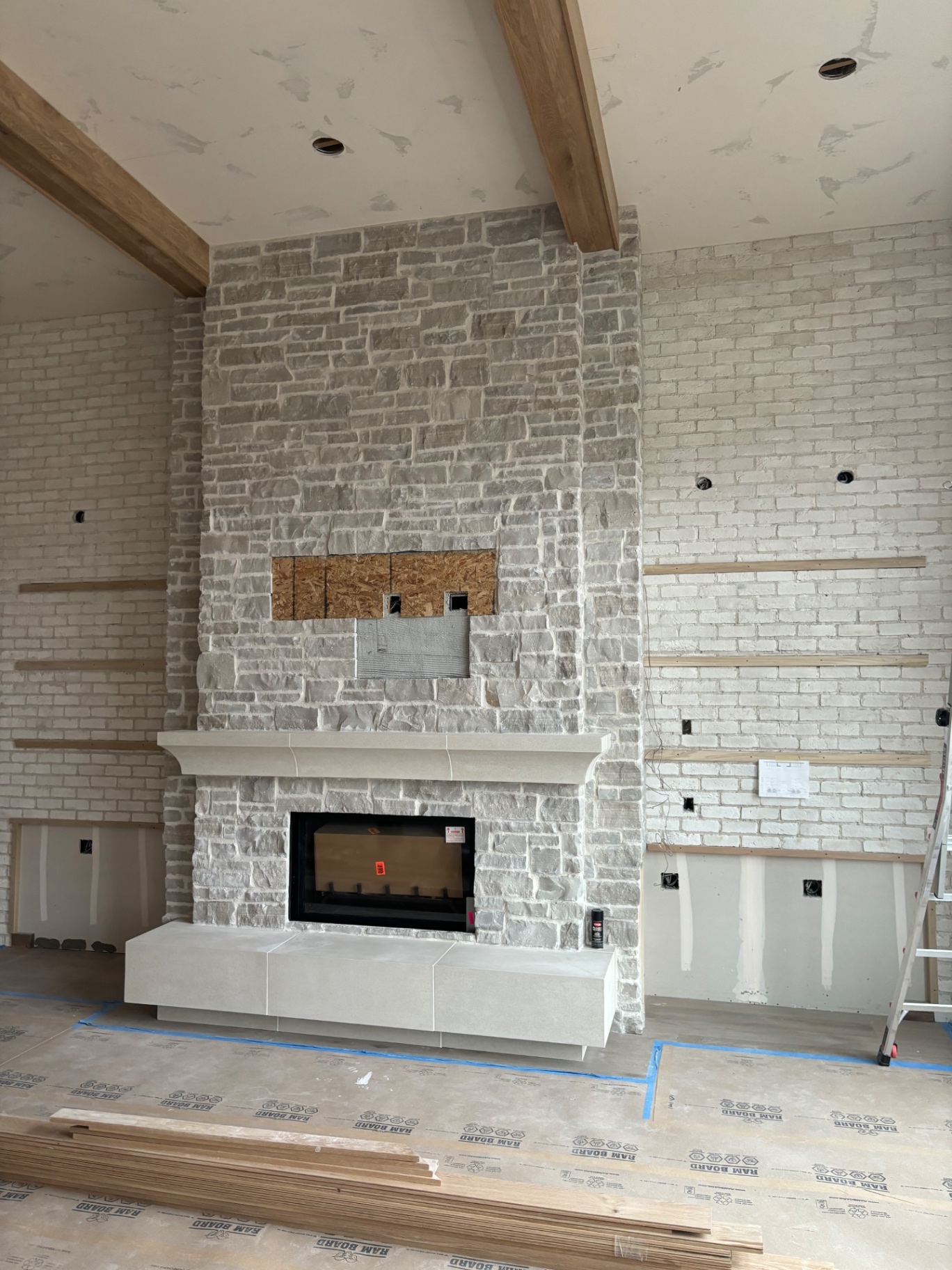 Stone fireplace with cast plaster mantel and hearth