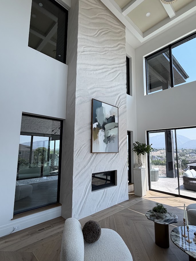 Tall white Venetian plaster fireplace wall with hand-troweled wave texture