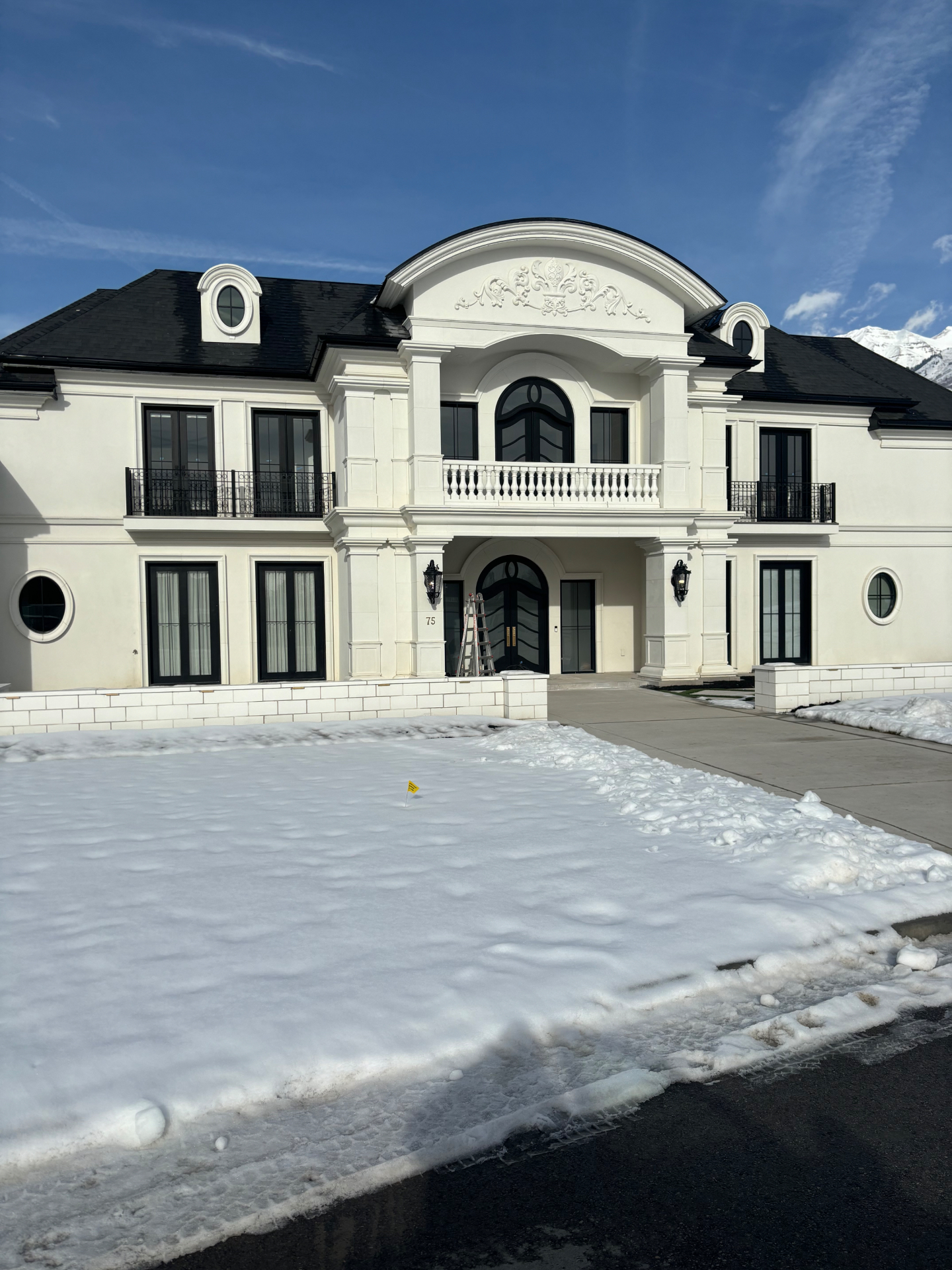 White stucco and cast stone estate exterior in Utah