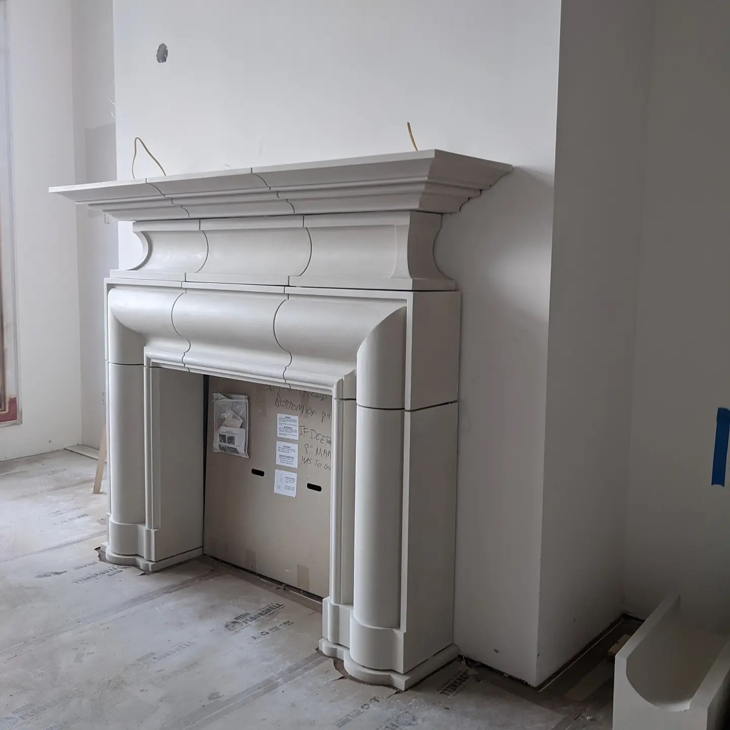 Ornate molded plaster fireplace mantel