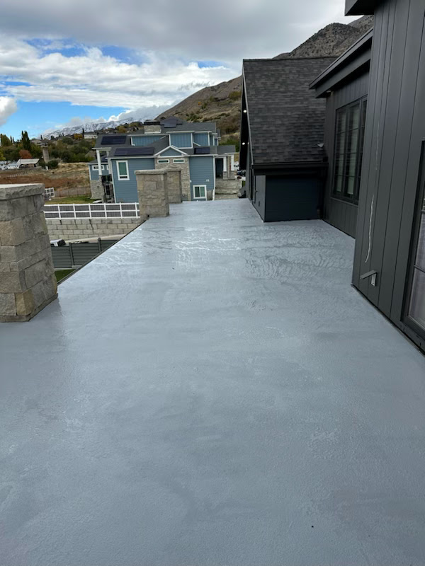 Gray waterproof deck coating on a rooftop terrace