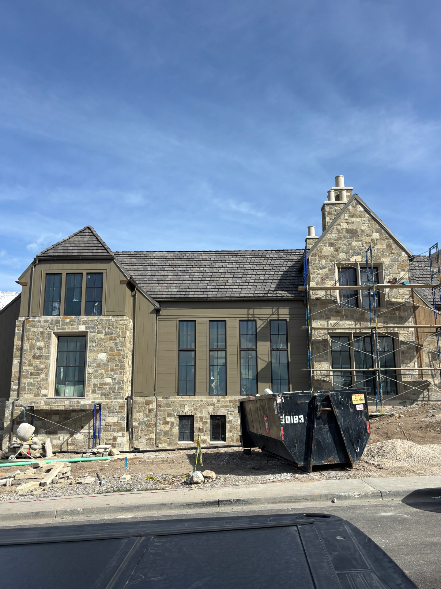 Custom home with natural stone masonry gables and siding