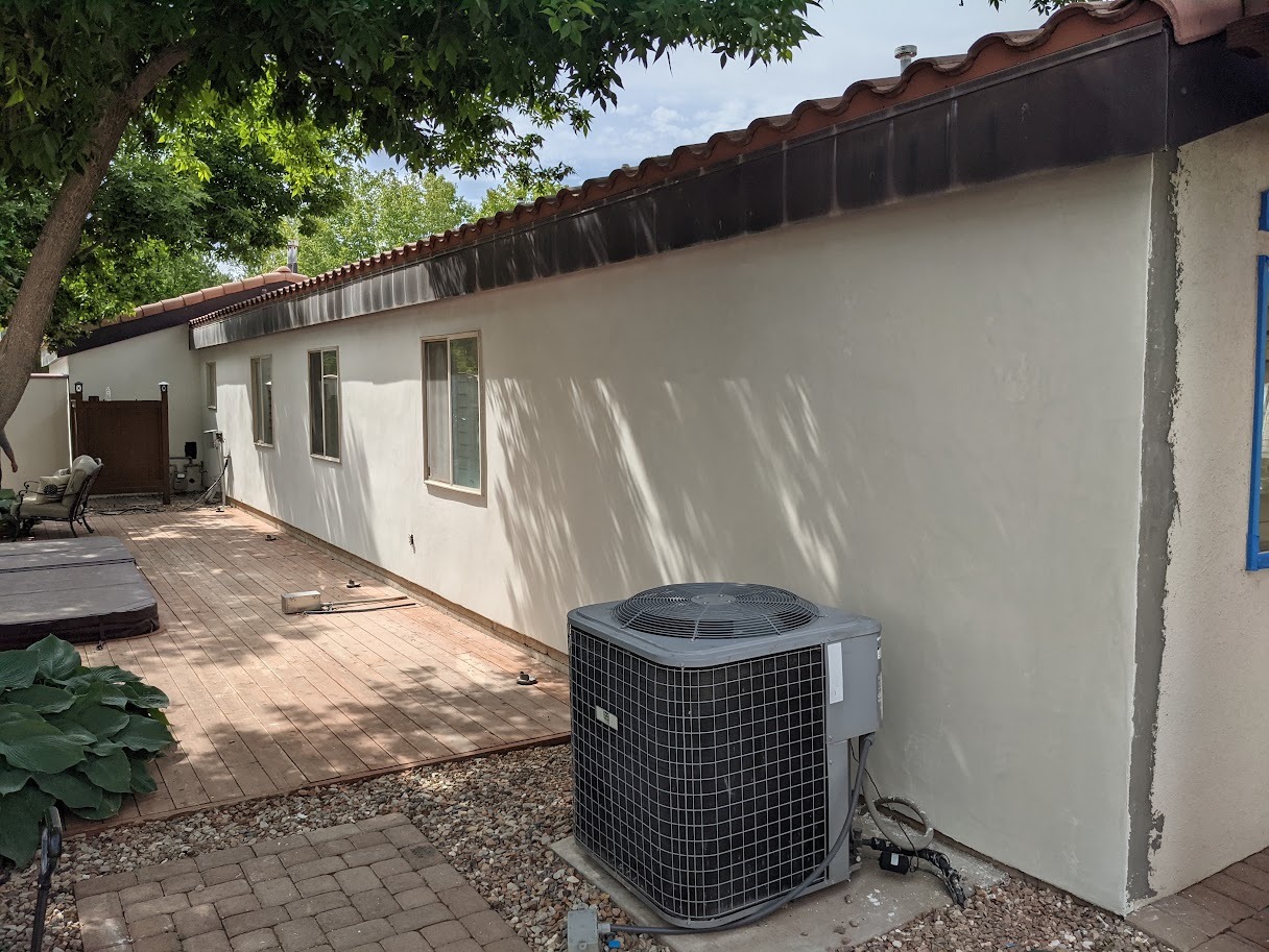 Smooth cream stucco home exterior with tile roof and clean corner detail