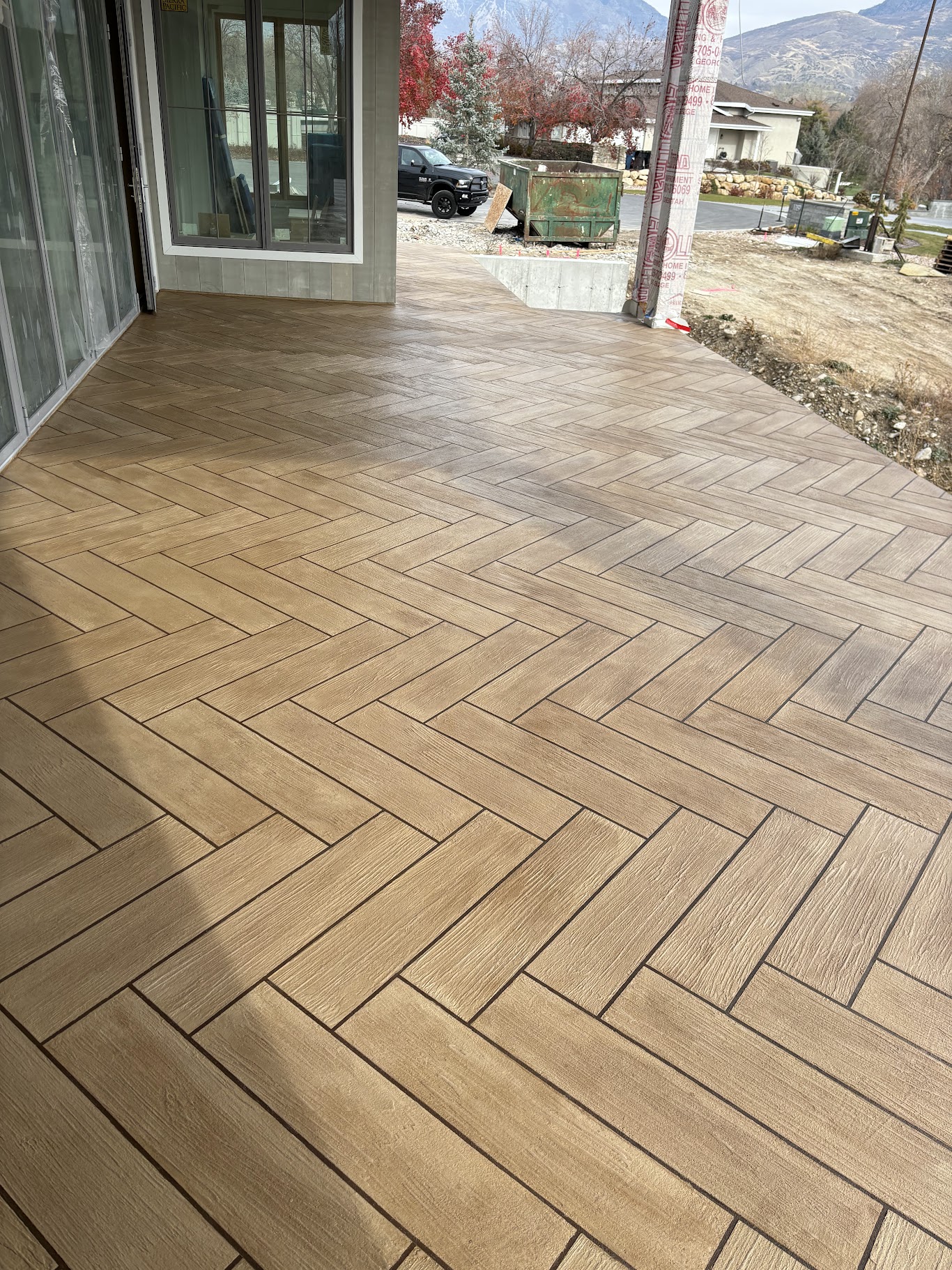 Wood-look waterproof deck tile pattern on a residential patio