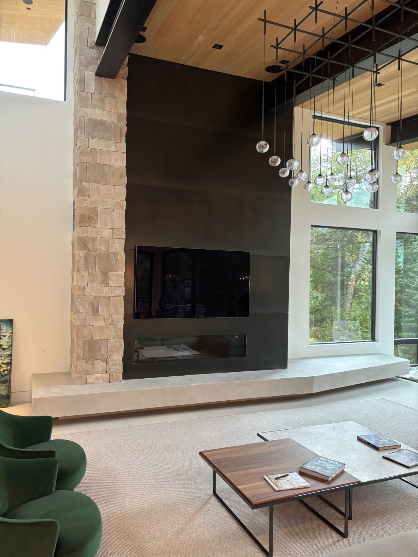 Modern great room with plaster hearth bench and steel fireplace