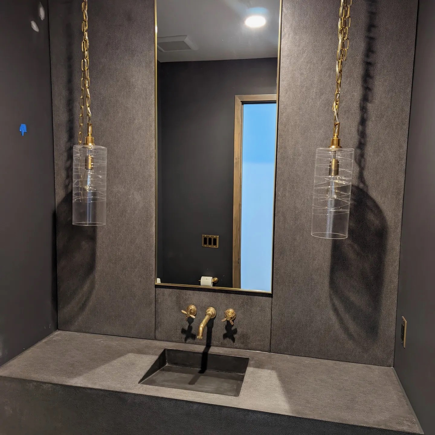 Textured plaster powder room walls and integrated vanity