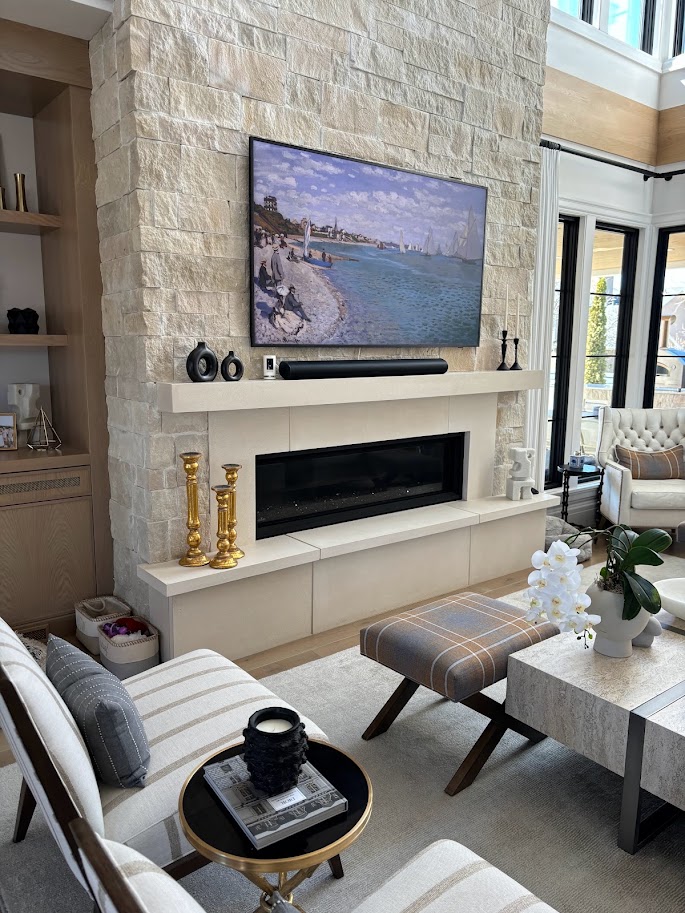 Cast limestone mantel and hearth bench on a stacked stone fireplace wall