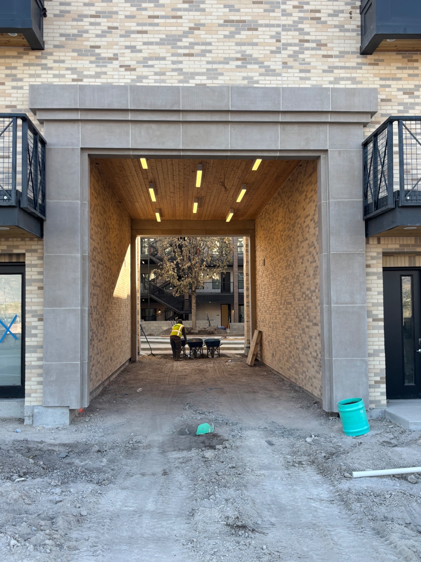 Cast stone archway surround on a brick multi-family building