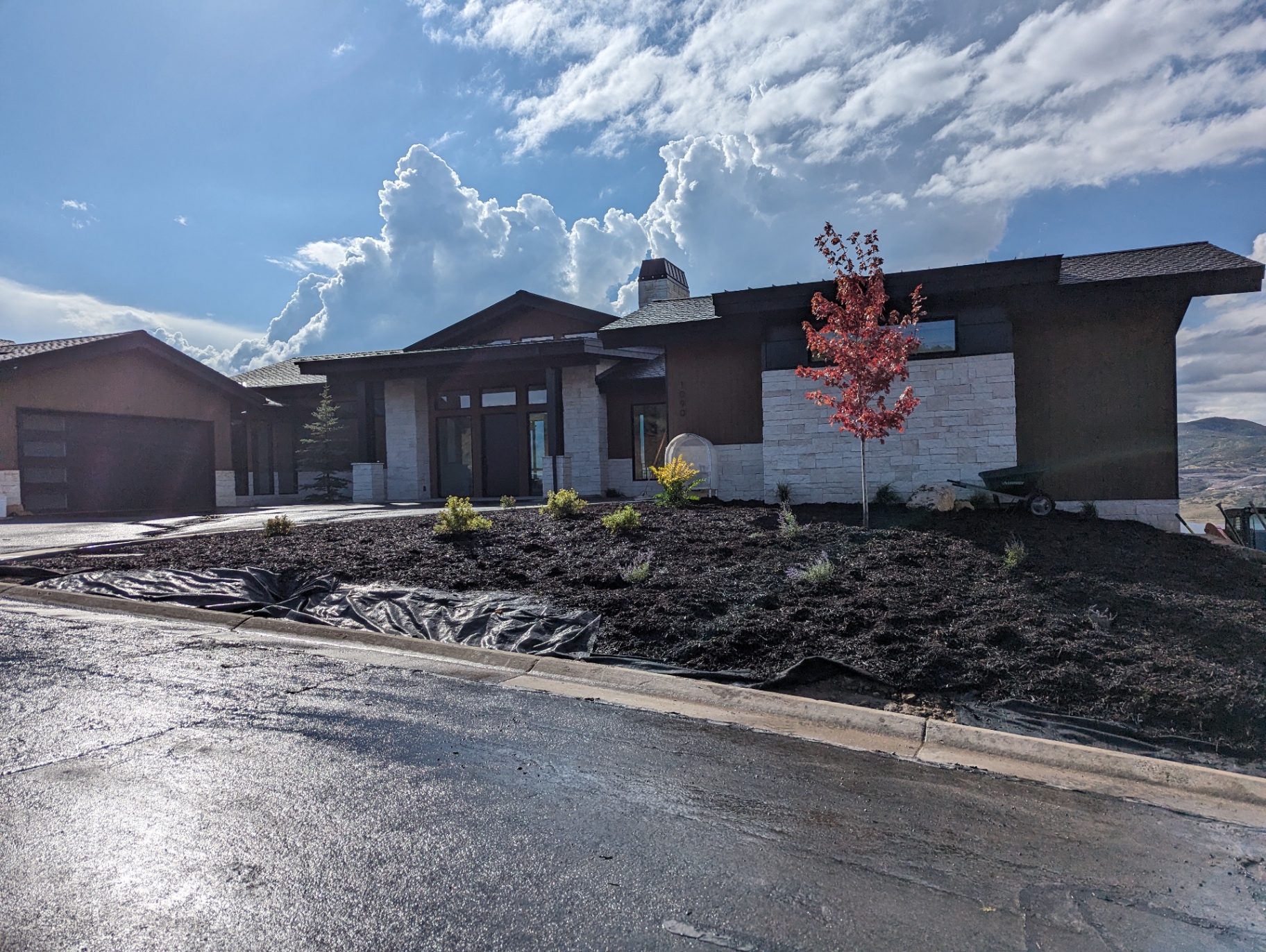 Hillside residence with stacked stone masonry and stucco finish