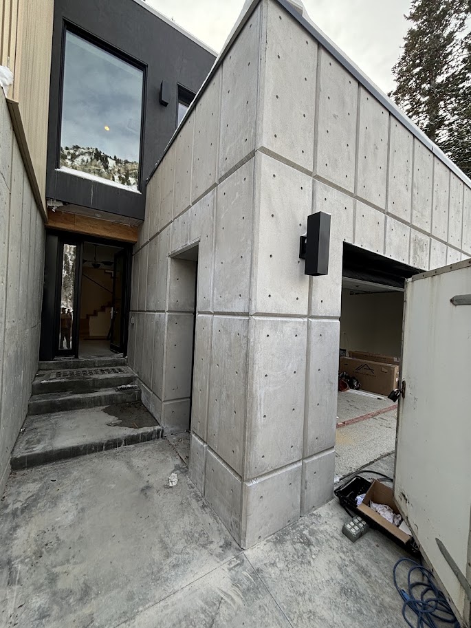 Cast concrete panel entry facade on a modern mountain home