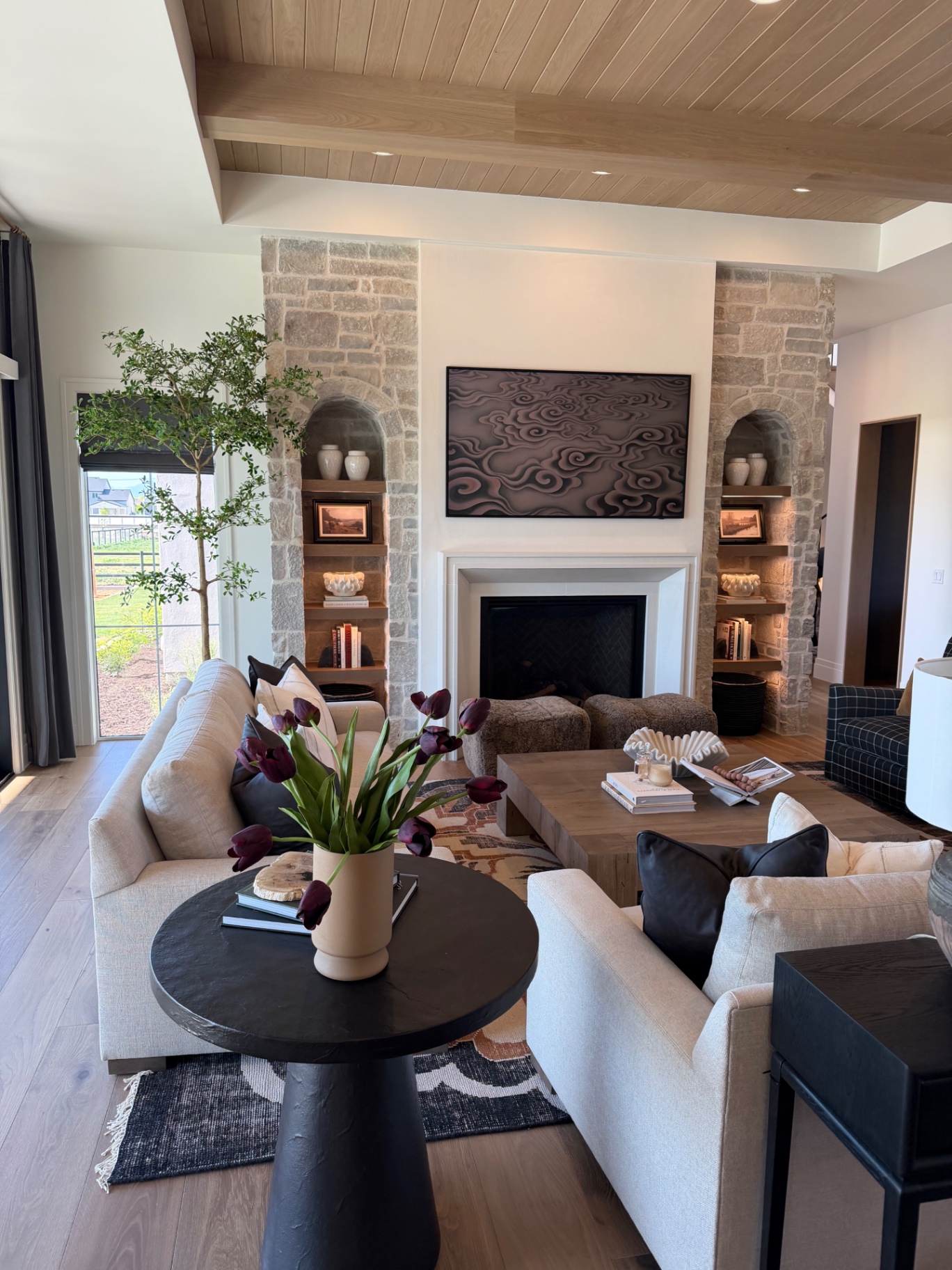 Great room with stone masonry niches flanking the fireplace