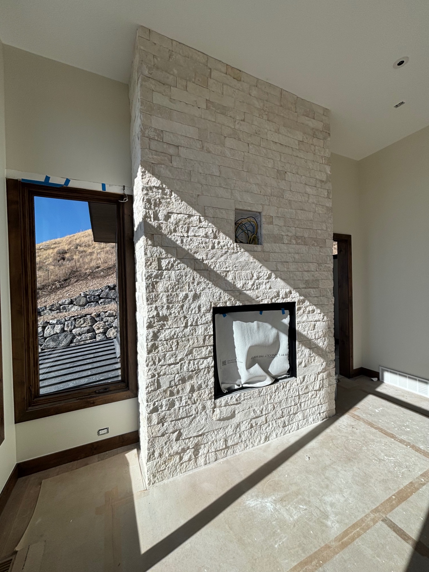 Interior limestone veneer fireplace wall