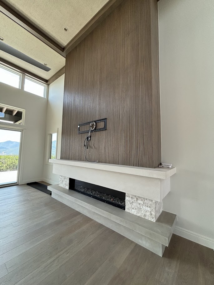 Modern cast limestone floating mantel and hearth with linear firebox