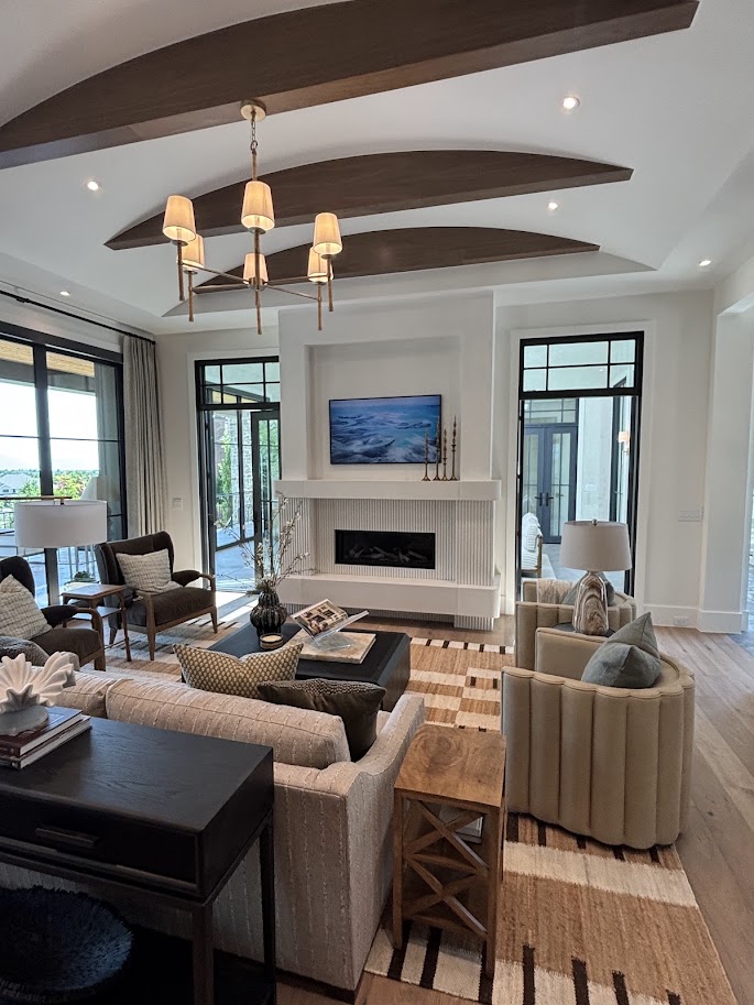 Fluted cast limestone fireplace surround in a beamed great room